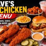 Dave's Hot Chicken menu featuring crispy hot chicken tenders, sliders, fries, and dipping sauces on a restaurant table.